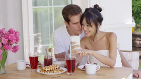 Happy-mixed-race-couple-taking-selfie