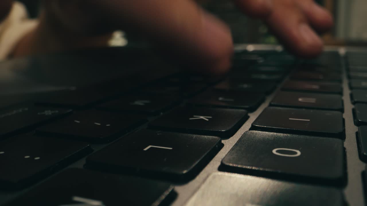 Closeup of hands typing on a laptop, showcasing productivity and advanced technology in a modern workspace