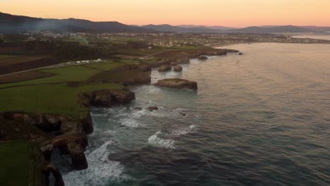 Aerial-view-of-Praia-das-Catedrais-rock-bound-cliff-formation-in-Spain-coastline-Atlantic-Ocean-sea-tourist-destination