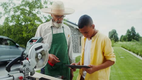 grandfather and grandson learning woodworking together