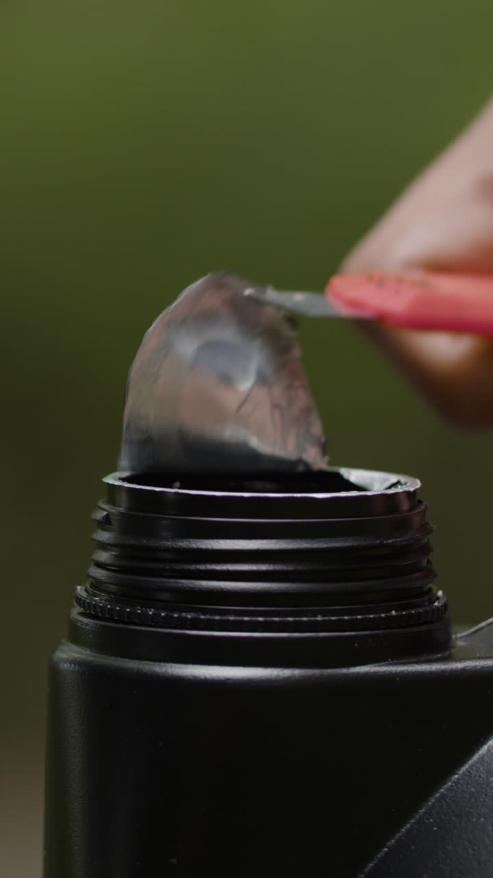 Opening a bottle with a utility knife