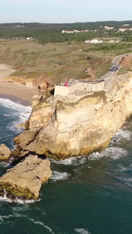 aerial view of nazare coastline in portugal with waves cliffs and atlantic ocean