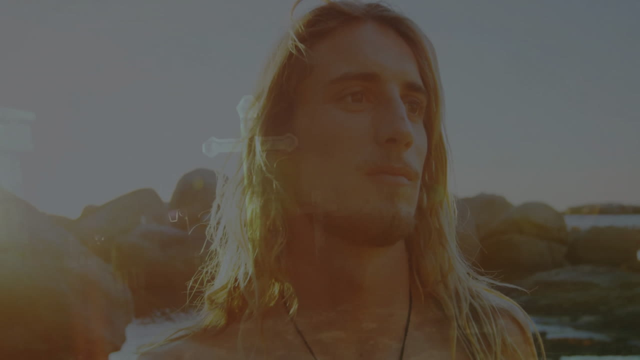 Standing by rocky shoreline during sunset, long-haired person watching animation