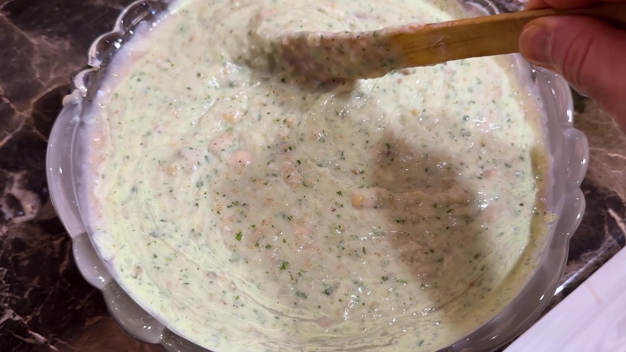 warm comforting Persian yogurt-based soup with soft creamy appearance and fresh herb-filled character It usually made with yogurt or dough rice small grains chopped herbs chickpeas or tiny meatballs