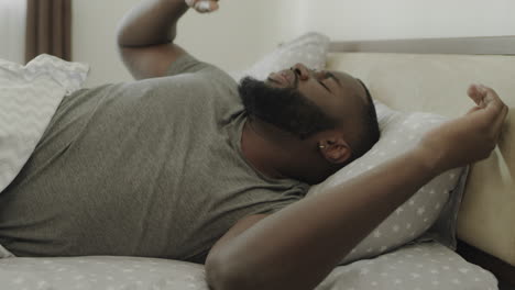 African-american-man-sleeping-on-the-bed-in-morning