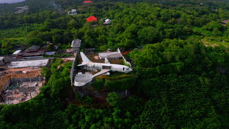 retired jet plane being repaired on jungle cliff and turned into hotel