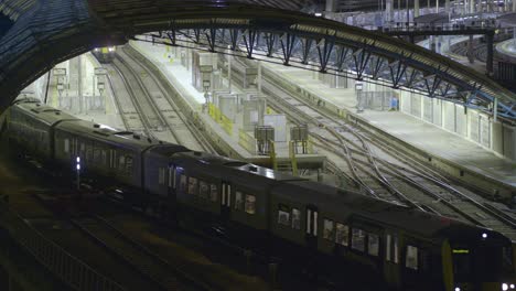 train departing london waterloo station at night time