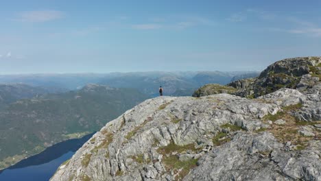 girl standing in breathtaking norwegian fjord landscapes