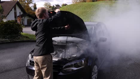 Frustrated-man-opening-hood-of-car-after-acciendent-on-road