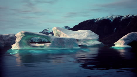 majestic iceberg arches gracefully above the calm water in remote wilderness