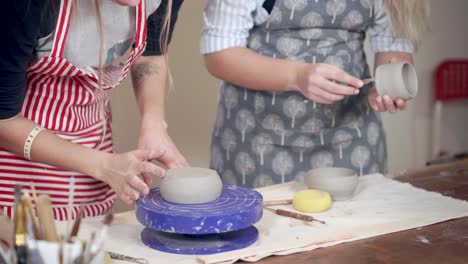 women making pottery on a pottery wheel