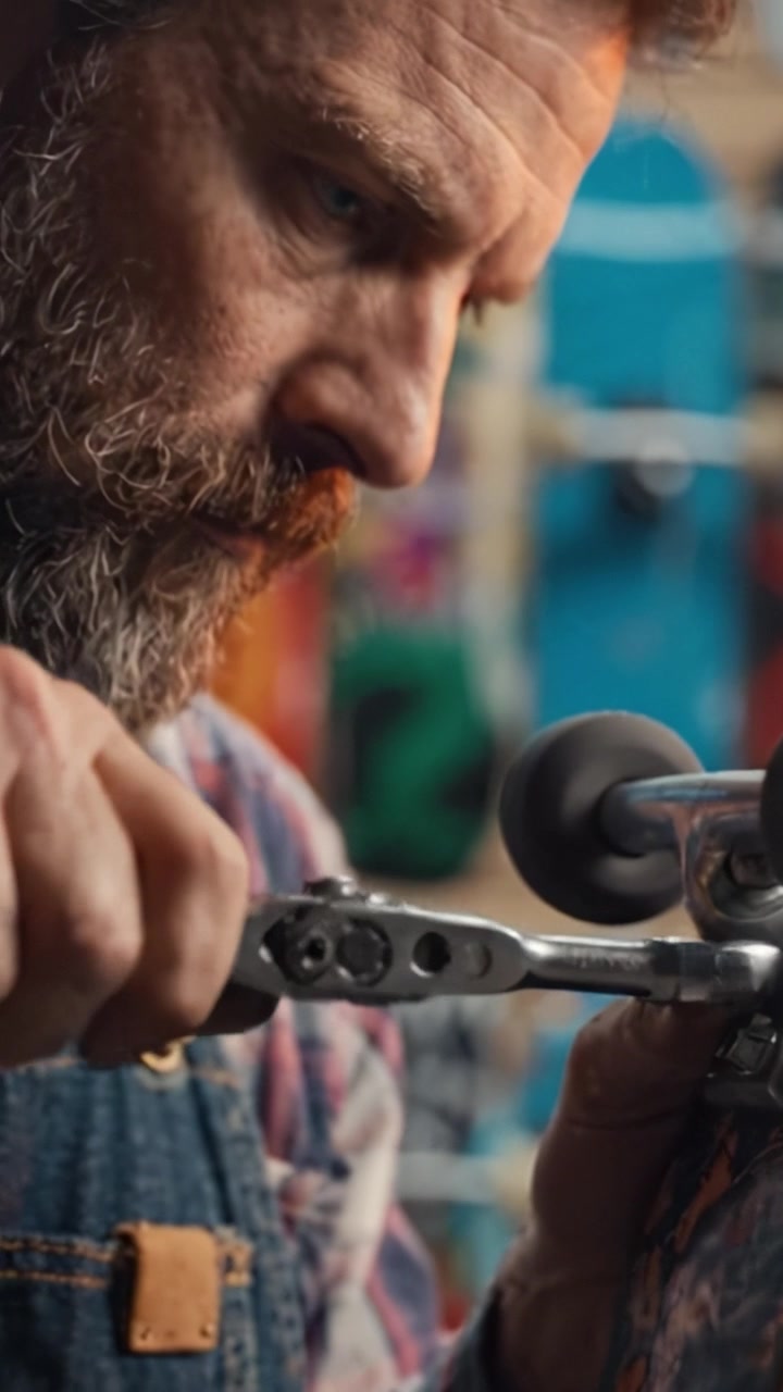 Expert Skateboard Repair: A Craftsman Fine-Tuning a Deck with Precision Tools in a Workshop Filled with Colorful Skateboards and Artistic Designs