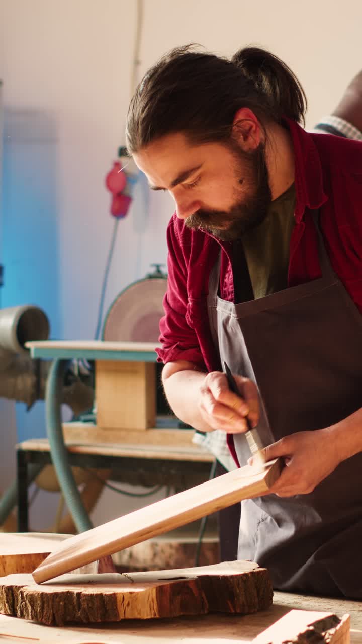 Craftsman Applying Varnish to a Wooden Plank in a Workshop