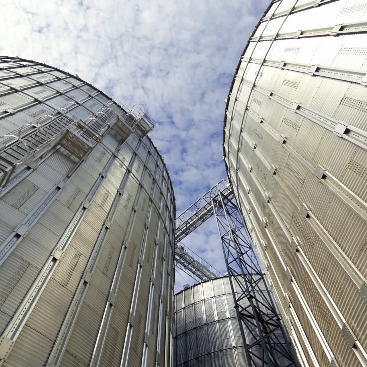 Industrial grain dryer. Modern complex for storage and further processing of grain. Large silos for keeping agricultural harvest. Close-up.