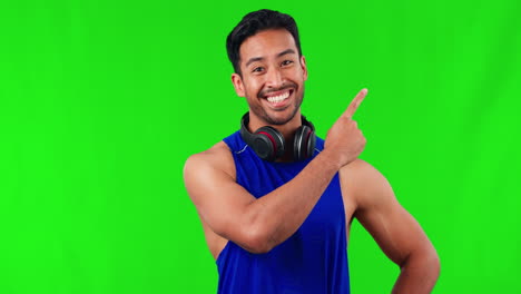 Pointing,-happy-and-man-in-a-studio-with-green