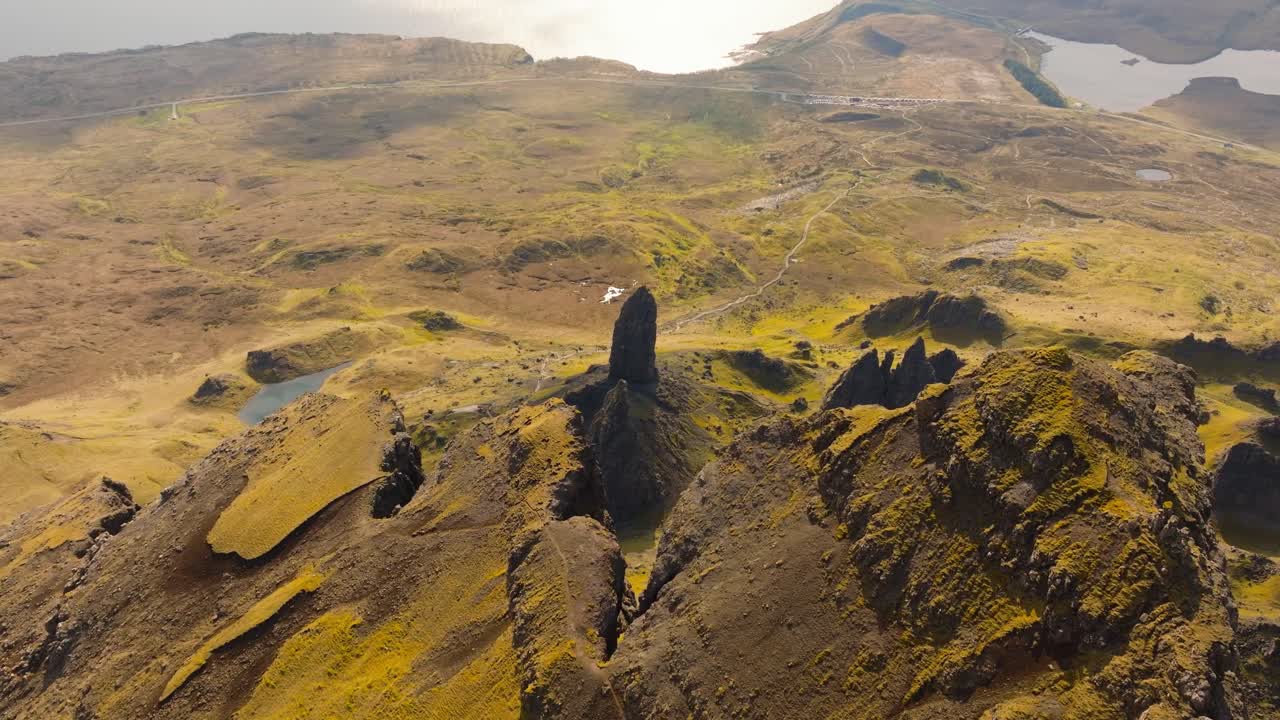 Aerial drone footage of the dramatic mountain landscapes on the Isle of Skye, Scotland. Sweeping panoramic views of majestic peaks, green valleys, and wild nature. Old man of Storr
