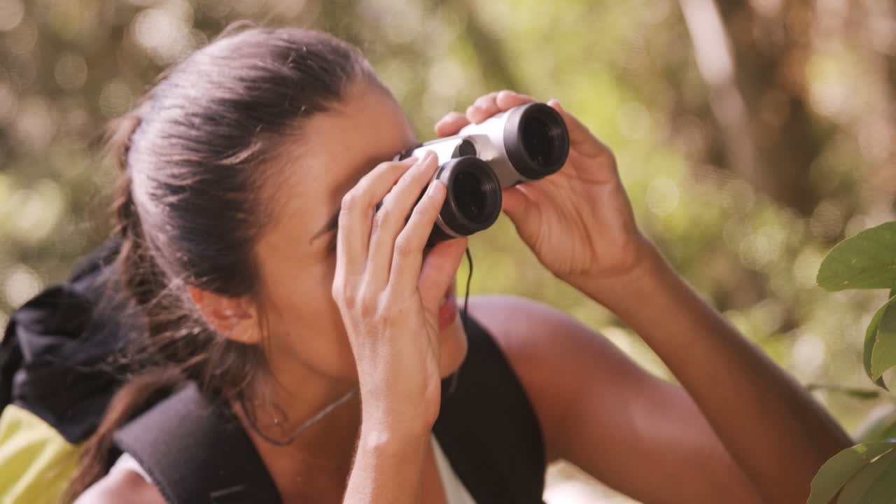 mujer joven mirando a través de binoculares