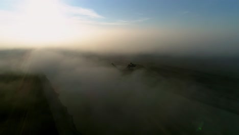 beautiful footage of a pond and an excavator hidden in fog