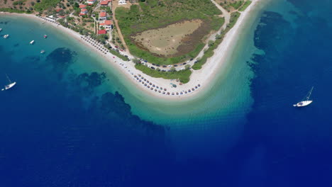 Aerial:-Slow-panning-drone-video-of-paradise-bay-and-sandy-beach-of-Agios-Dimitrios-with-amazing-turquoise-and-emerald-clear-water,-Alonnisos-island,-Sporades,-Greece