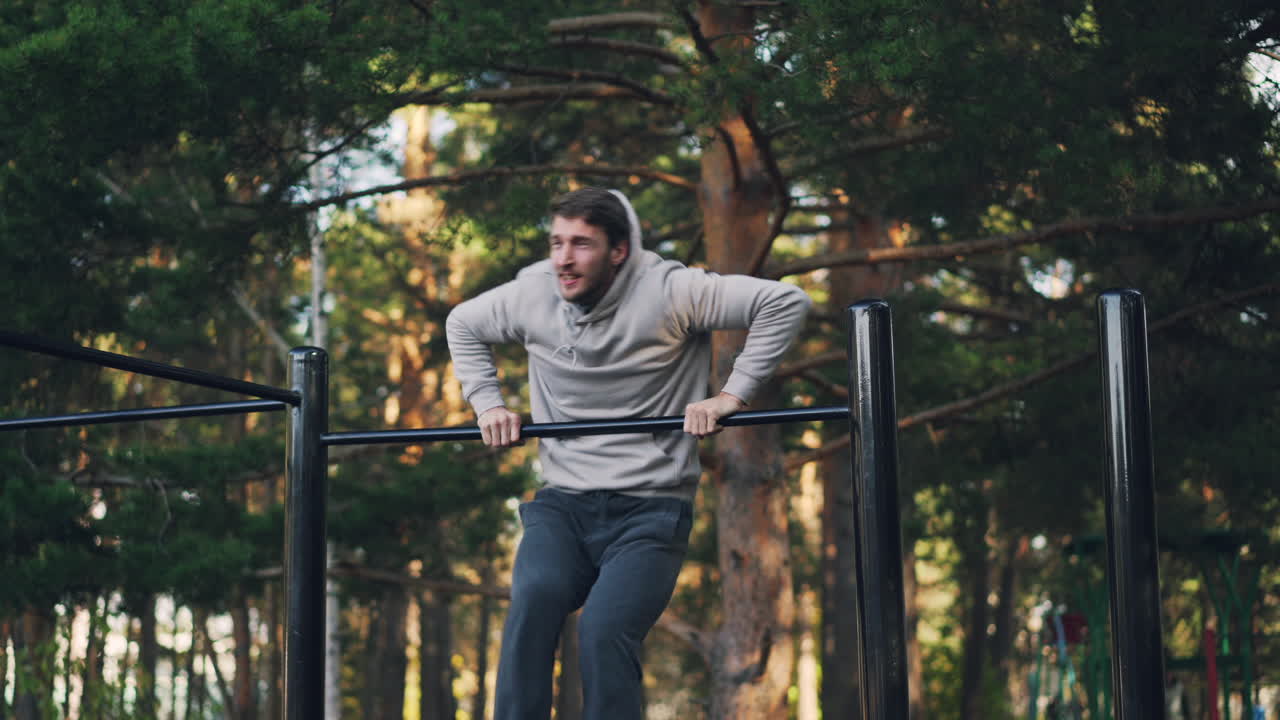 hombre haciendo pull-ups en un parque