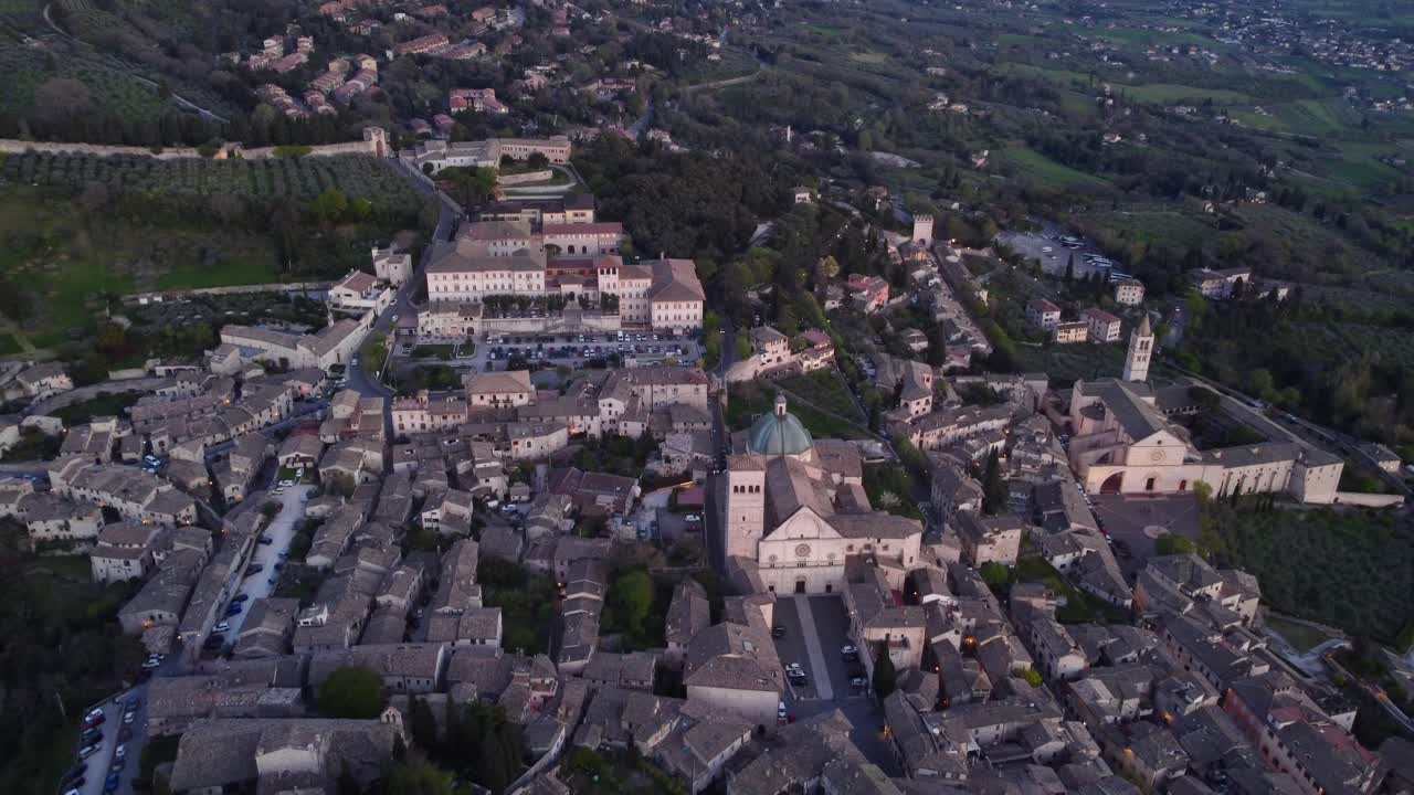High angle view of Assisi's city of peace, Umbria, Italy, aerial, sunset, 4k
