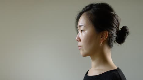 asian woman putting on face mask b