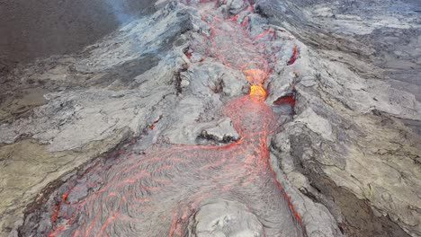 aerial of hot molten lava flowing in a river from fagradalsfjall volcano on the reykjanes peninsula in iceland