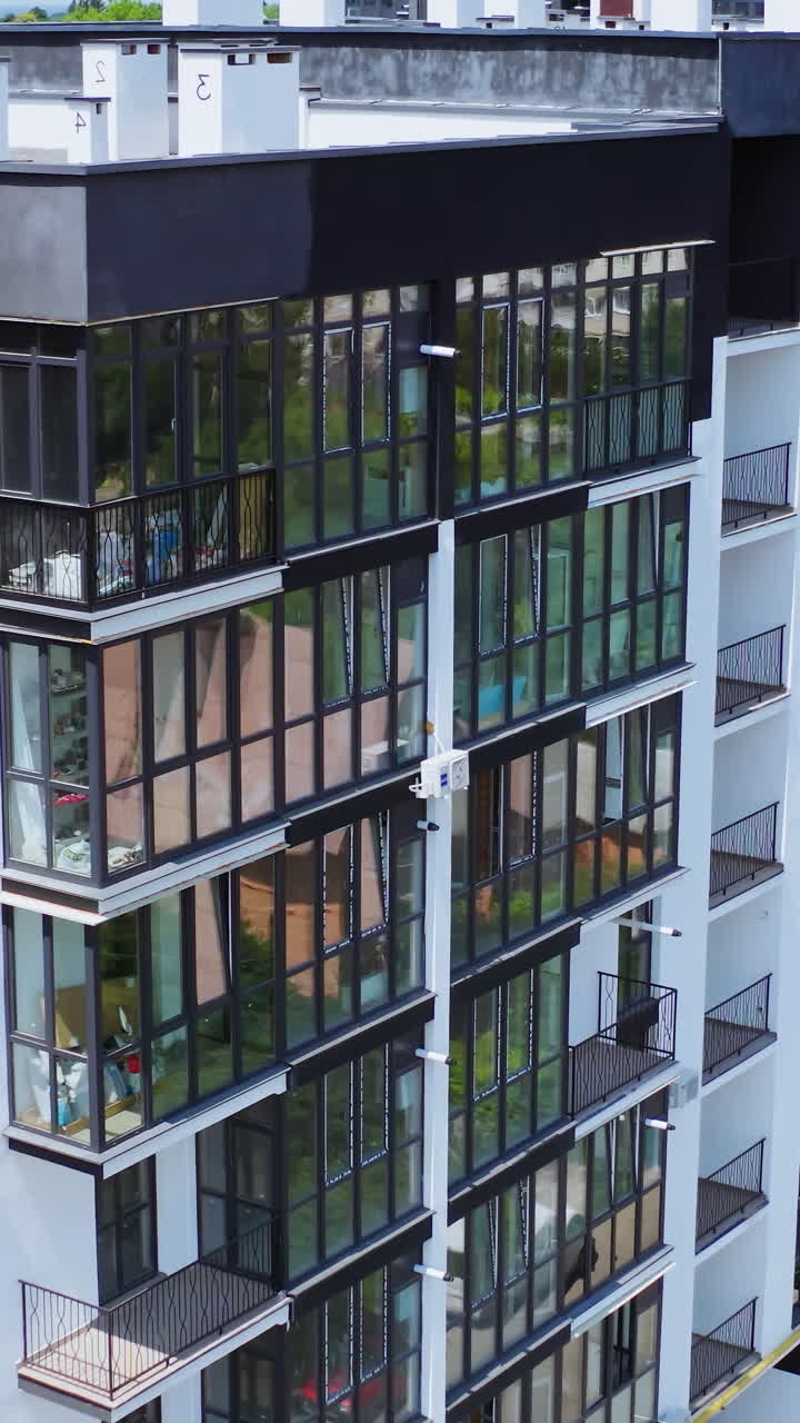 Drone view of standard apartment. Aerial view of the city with multi storey residential buildings. Vertical video