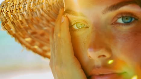 close-up video shot of a person's eye, capturing sunlight reflections through a woven hat