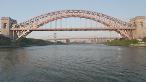 aerial view of the hell gate bridge, shot at sunrise in new york city