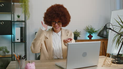 happy business woman looking approvingly at camera showing thumbs up, like positive sign, good news