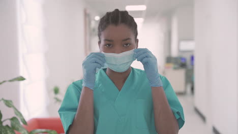 young woman doctor looks directly into the camera