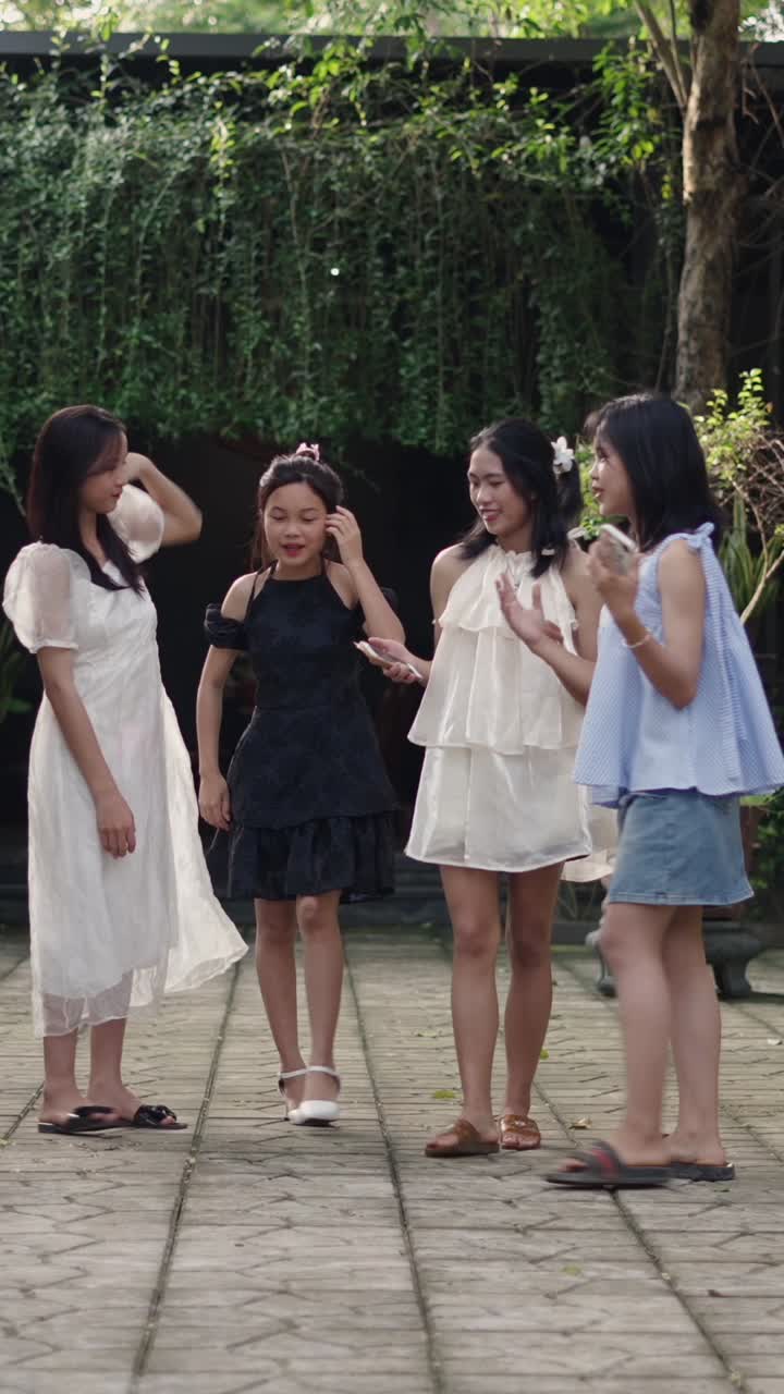 Three young women in dresses walking outdoors