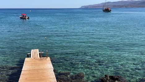 tranquil seaside scene with clear blue water and boats