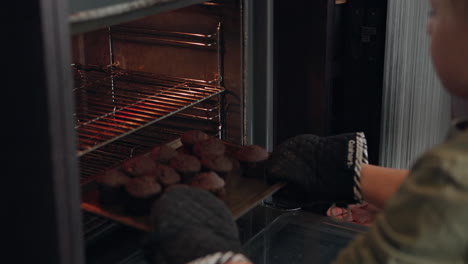 grandmother and child baking cupcakes in the oven