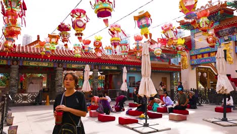 visitors explore colorful temple decorations and surroundings