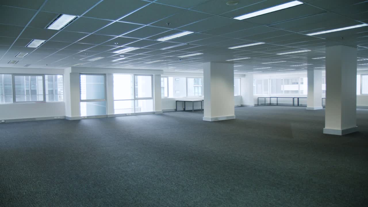 Empty commercial office space with no desks and carpet floor