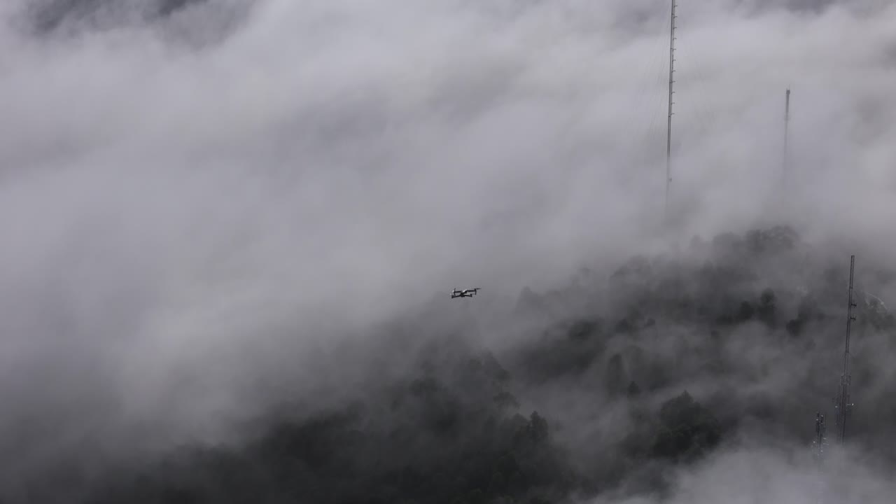 Drone flying above the low clouds that were rolling on the mountains of Portugal