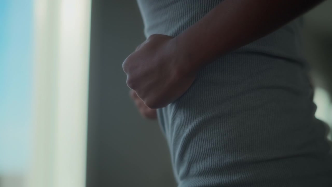 Close up of a young man exercising on a treadmill at home