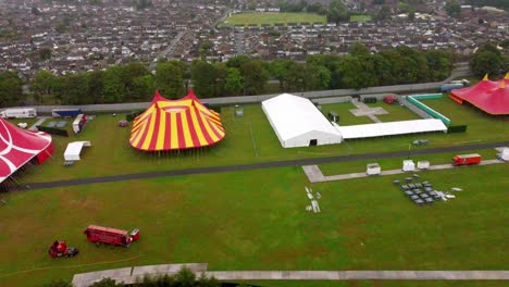 arcing aerial shot revealing multiple tents