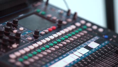 professional sound mixer - music pad at an edm concert in slow motion with green and white buttons.