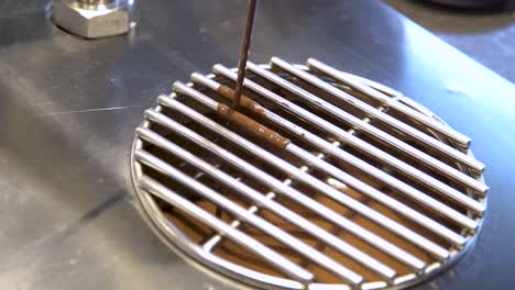 milk chocolate sauce pouring into commercial kitchen mixer and mixing