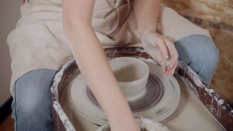 woman working on a pottery wheel