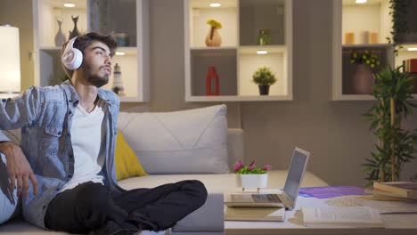 depressed man listening to music at home at night.