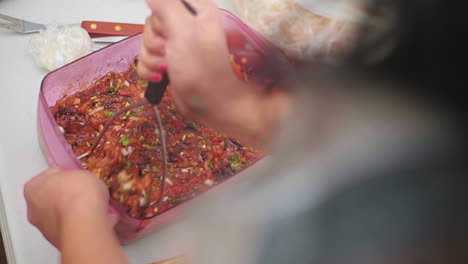 Hot-Spicy-Serrano-Chilli-and-Habanero-Chilli-into-Tomato-Sauce-being-Mashed