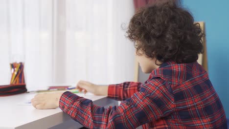 Dreamy-boy-drawing-at-home.-Dream-of-being-a-painter.