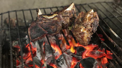 close up of delicious steak grilling over charcoal fire