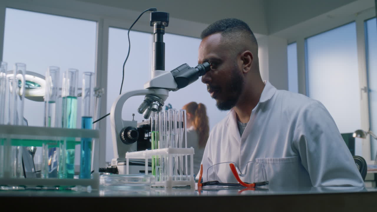 Scientist using microscope in laboratory