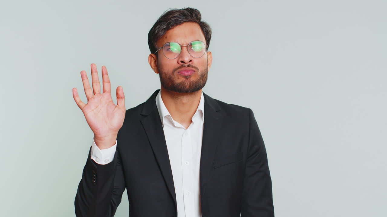 el hombre de negocios indio agita el dedo y dice no, ten cuidado, evita el peligro error, señal de desaprobación