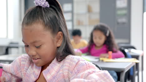 in school, diverse group of young students focusing on their work in the classroom